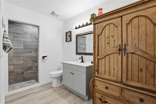 a bathroom with a toilet a sink and mirror