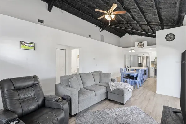 a living room with furniture and a glass door