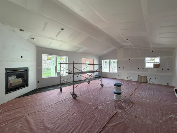 a view of a livingroom with fireplace and window