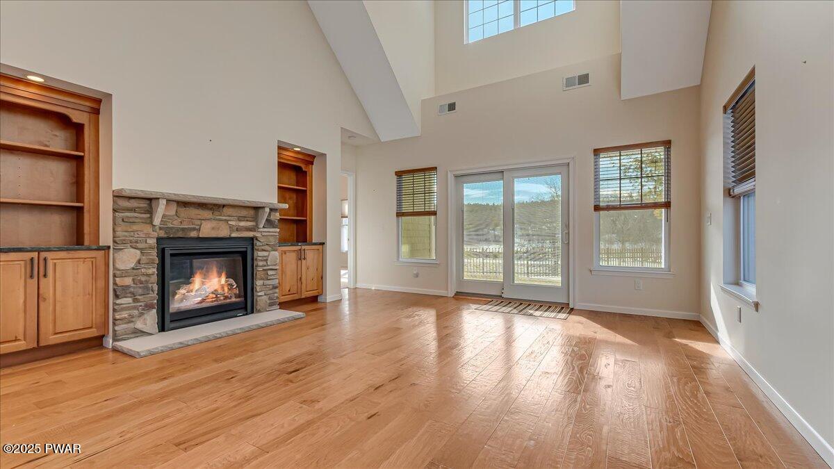 1010 MacIntosh Way Matamoras, PA 18336 - Photo 4 of 60 a view of an empty room with wooden floor fireplace and a window