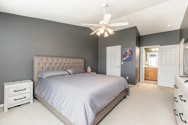 a bedroom with a bed and a chandelier