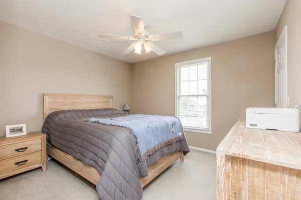 a spacious bedroom with a bed and window
