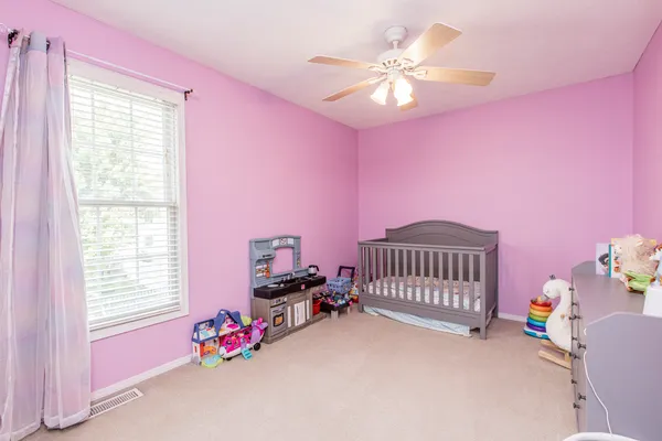 a bedroom with furniture and a window