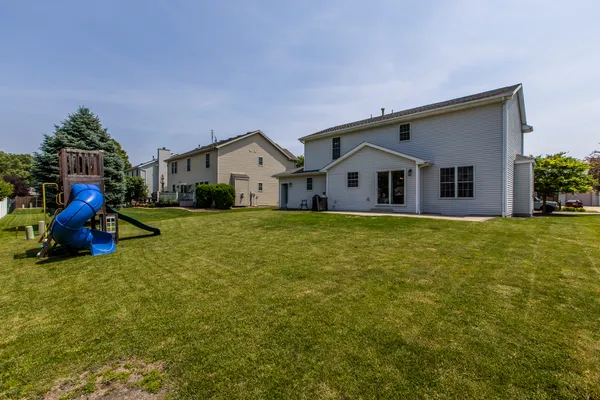 a view of house with outdoor space and sitting area