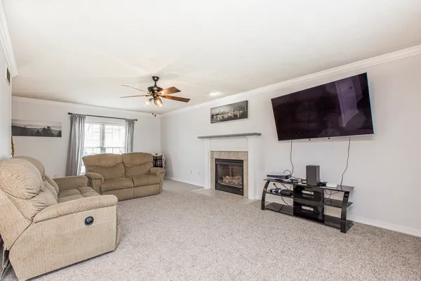 a living room with furniture and a flat screen tv