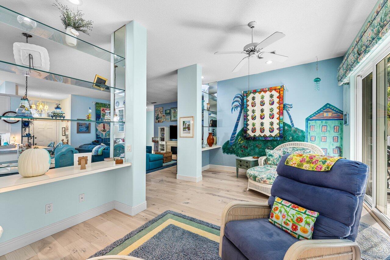 198 Hampton Circle Jupiter, FL 33458 - Photo 12 of 32 a living room with furniture and a chandelier