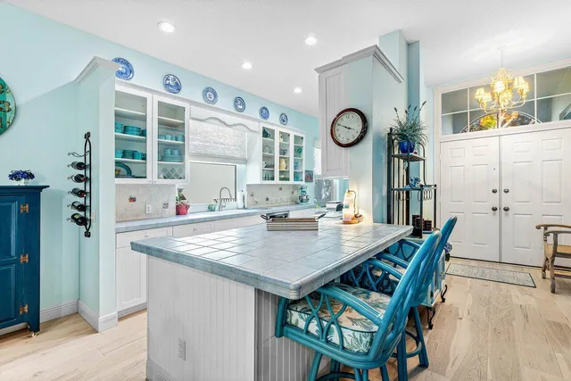 a view of kitchen island with stainless steel appliances granite countertop furniture and a large window