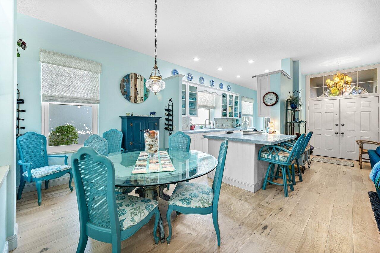 198 Hampton Circle Jupiter, FL 33458 - Photo 14 of 32 a view of a dining room with furniture and wooden floor