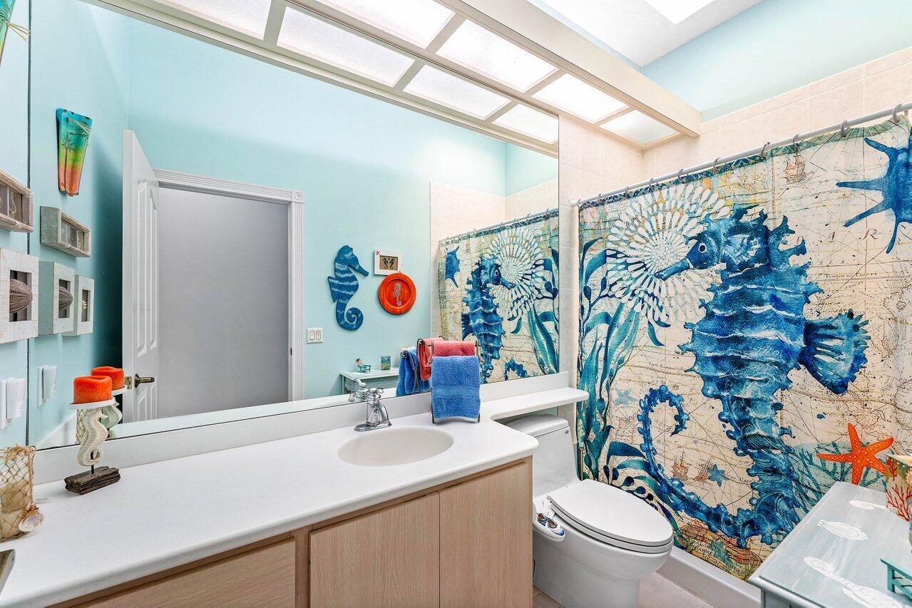 198 Hampton Circle Jupiter, FL 33458 - Photo 20 of 32 a bathroom with a sink mirror vanity and toilet