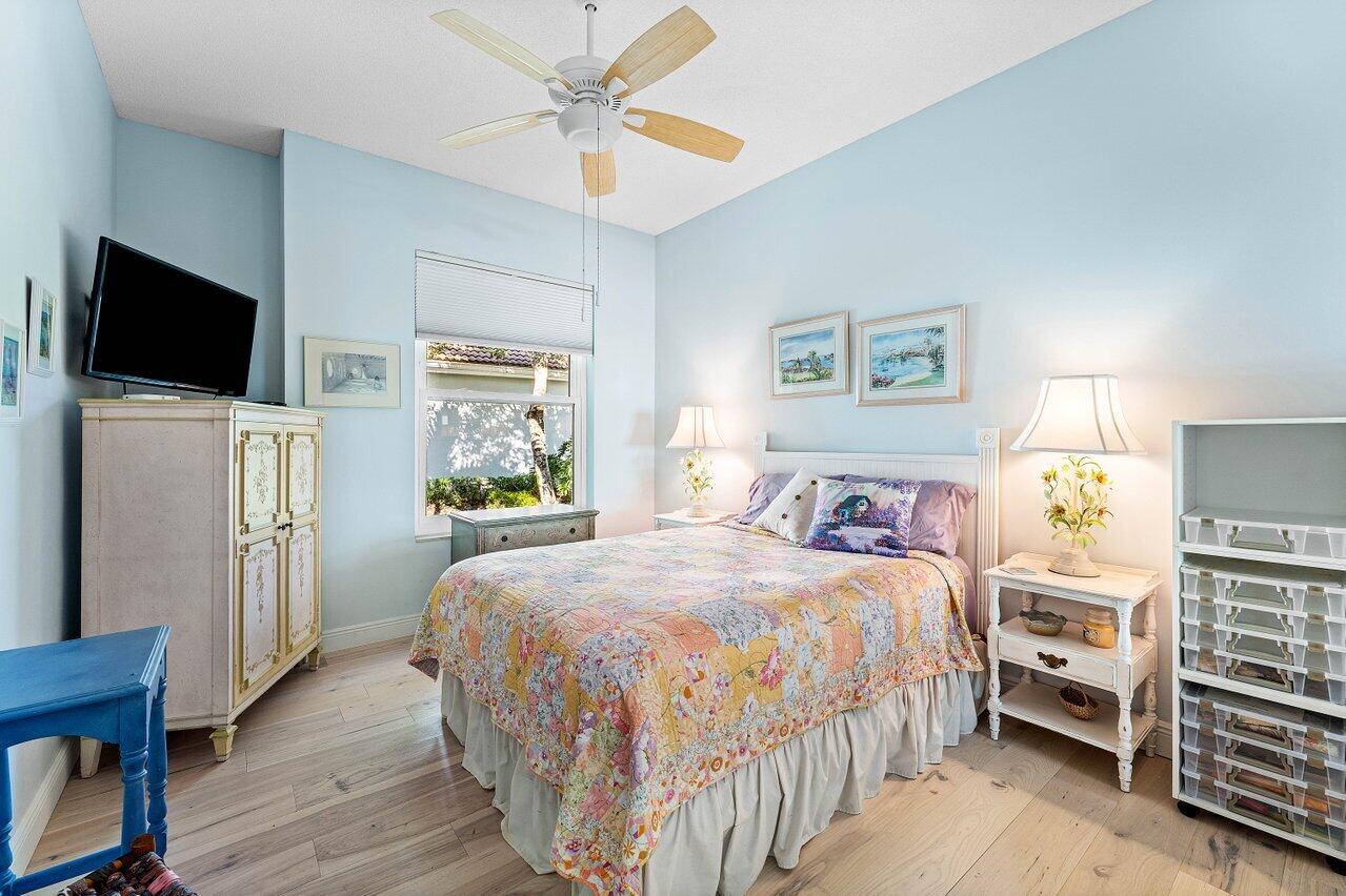 198 Hampton Circle Jupiter, FL 33458 - Photo 21 of 32 a bedroom with a bed and a flat screen tv