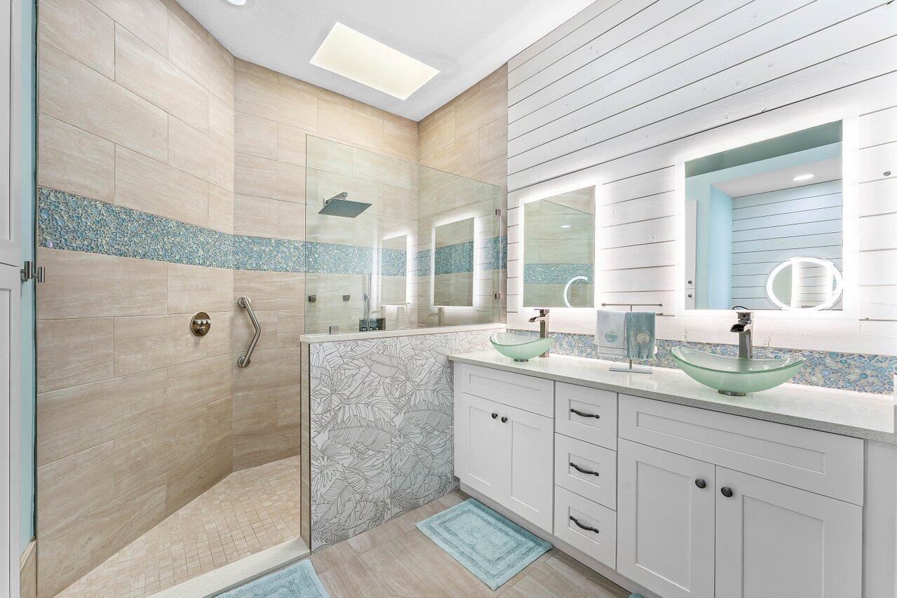 198 Hampton Circle Jupiter, FL 33458 - Photo 26 of 32 a bathroom with a granite countertop sink mirror and