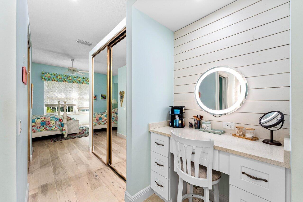 198 Hampton Circle Jupiter, FL 33458 - Photo 27 of 32 a en suite bathroom with a double vanity sink and a mirror