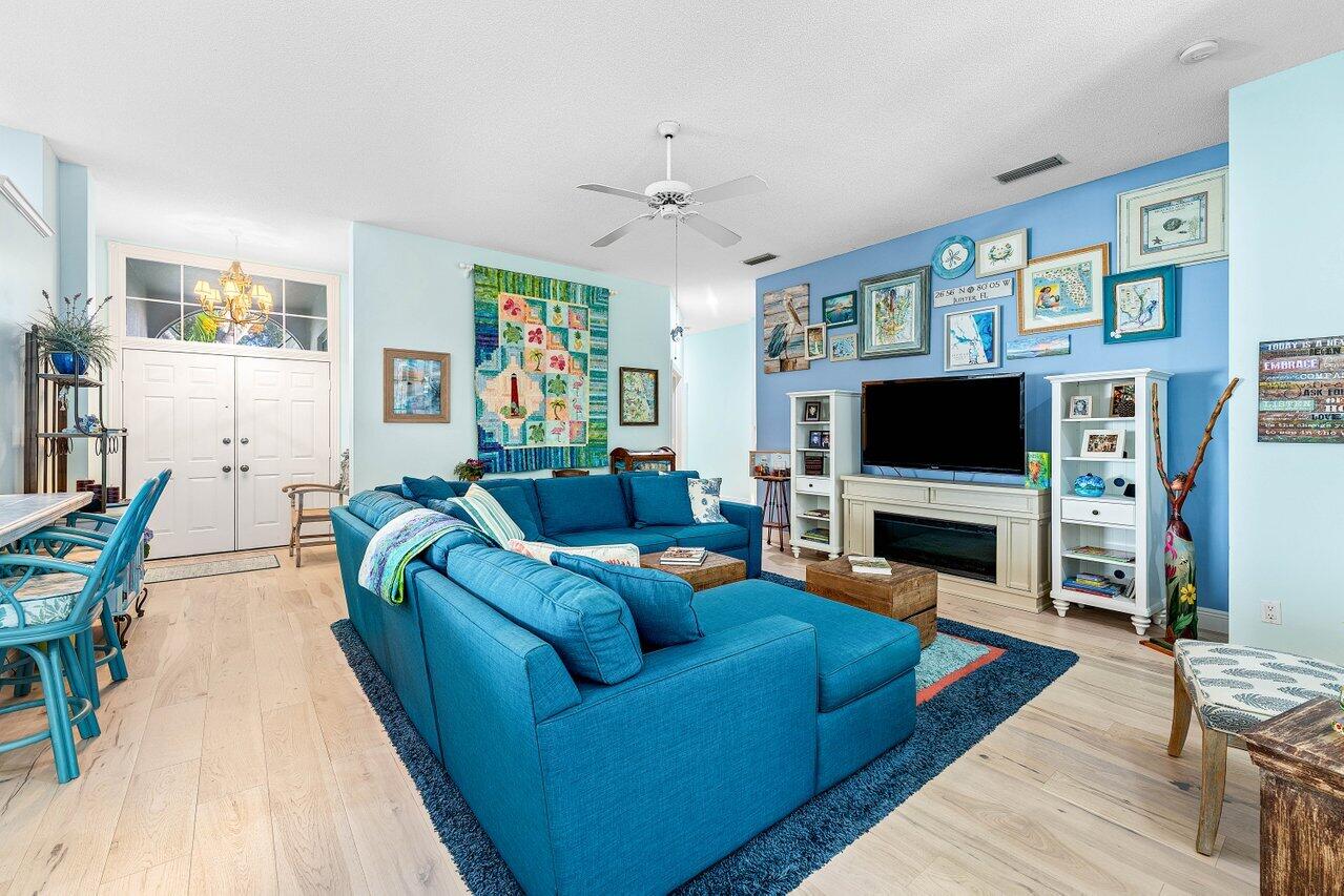 198 Hampton Circle Jupiter, FL 33458 - Photo 6 of 32 a living room with furniture a flat screen tv and a fireplace