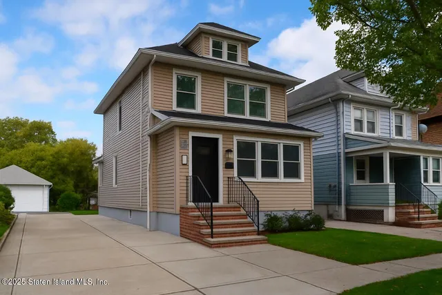 a front view of a house with a garden