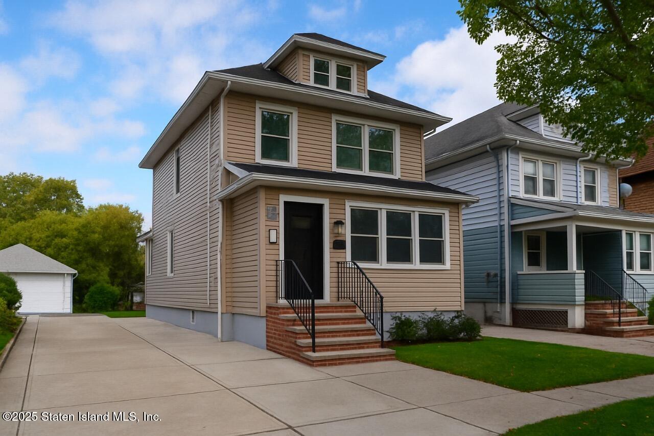 a front view of a house with a garden