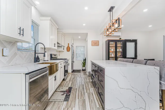 a kitchen with stainless steel appliances a sink stove and cabinets