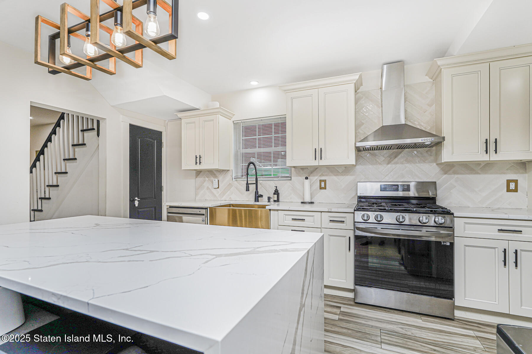 145 Clinton Place Staten Island, NY 10302 - Photo 15 of 41 a kitchen with stainless steel appliances a stove a sink and cabinets