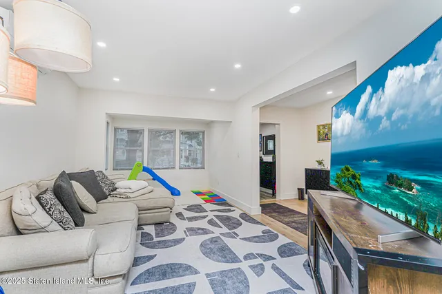 a living room with furniture and a floor to ceiling window