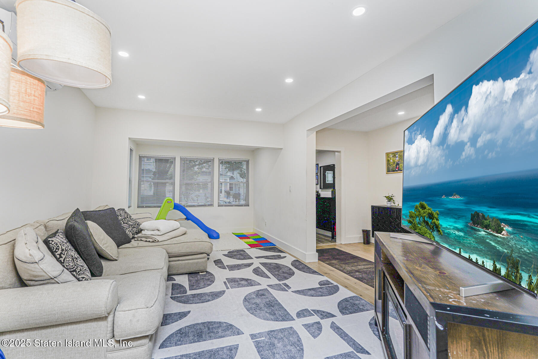 145 Clinton Place Staten Island, NY 10302 - Photo 22 of 41 a living room with furniture and a floor to ceiling window
