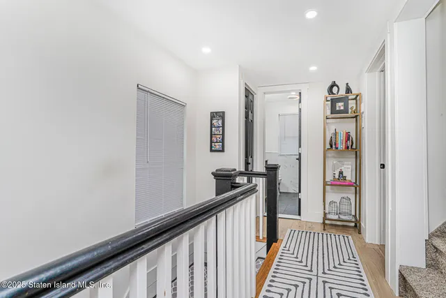a view of a hallway with paintings on the wall