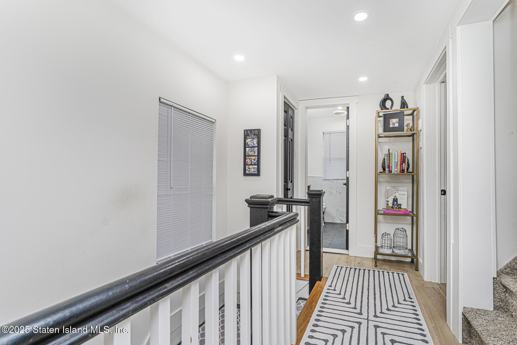 145 Clinton Place Staten Island, NY 10302 - Photo 24 of 41 a view of a hallway with paintings on the wall