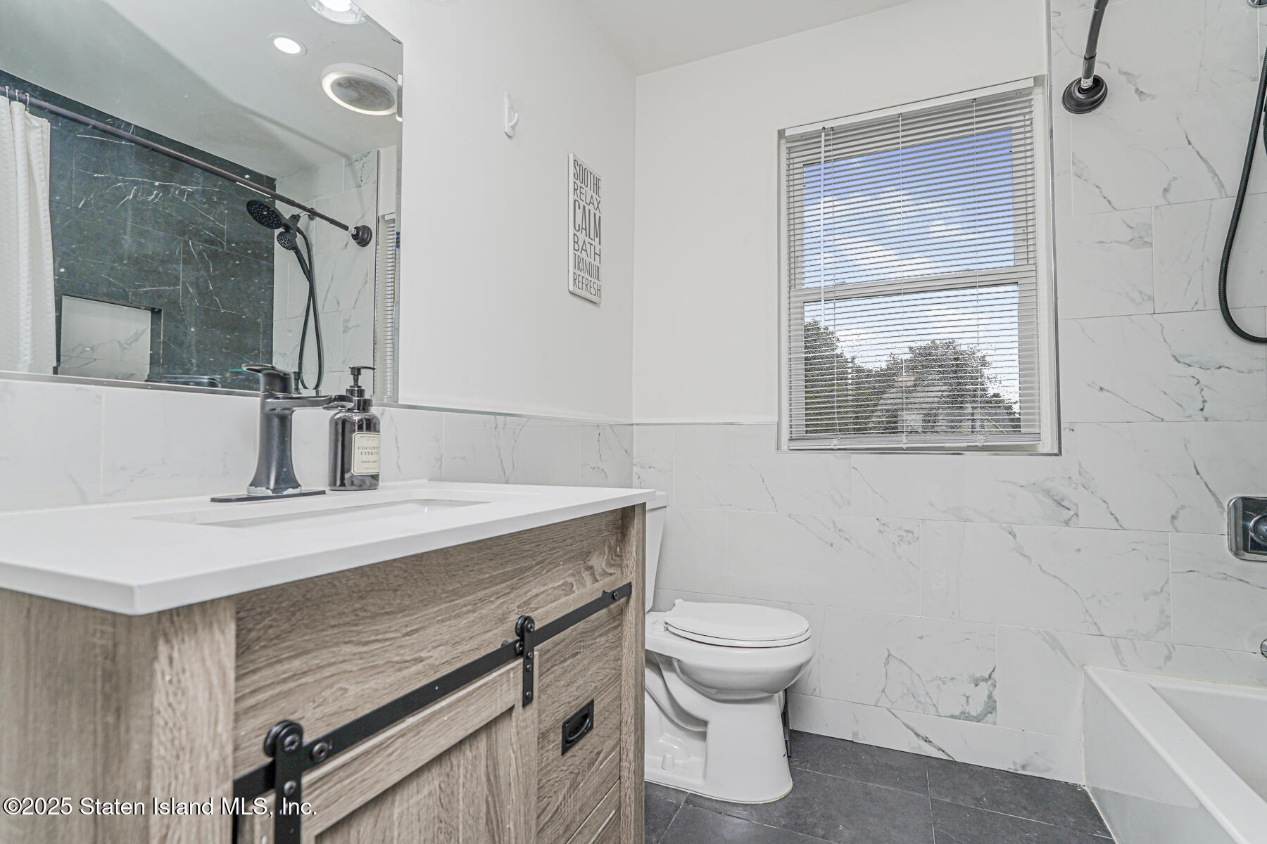 145 Clinton Place Staten Island, NY 10302 - Photo 32 of 41 a bathroom with a sink a toilet and shower