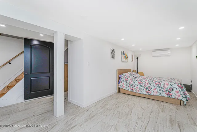 a very nice looking bedroom with a bed and a dresser