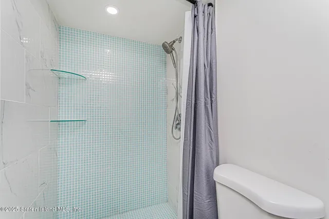 a bathroom with a shower and toilet
