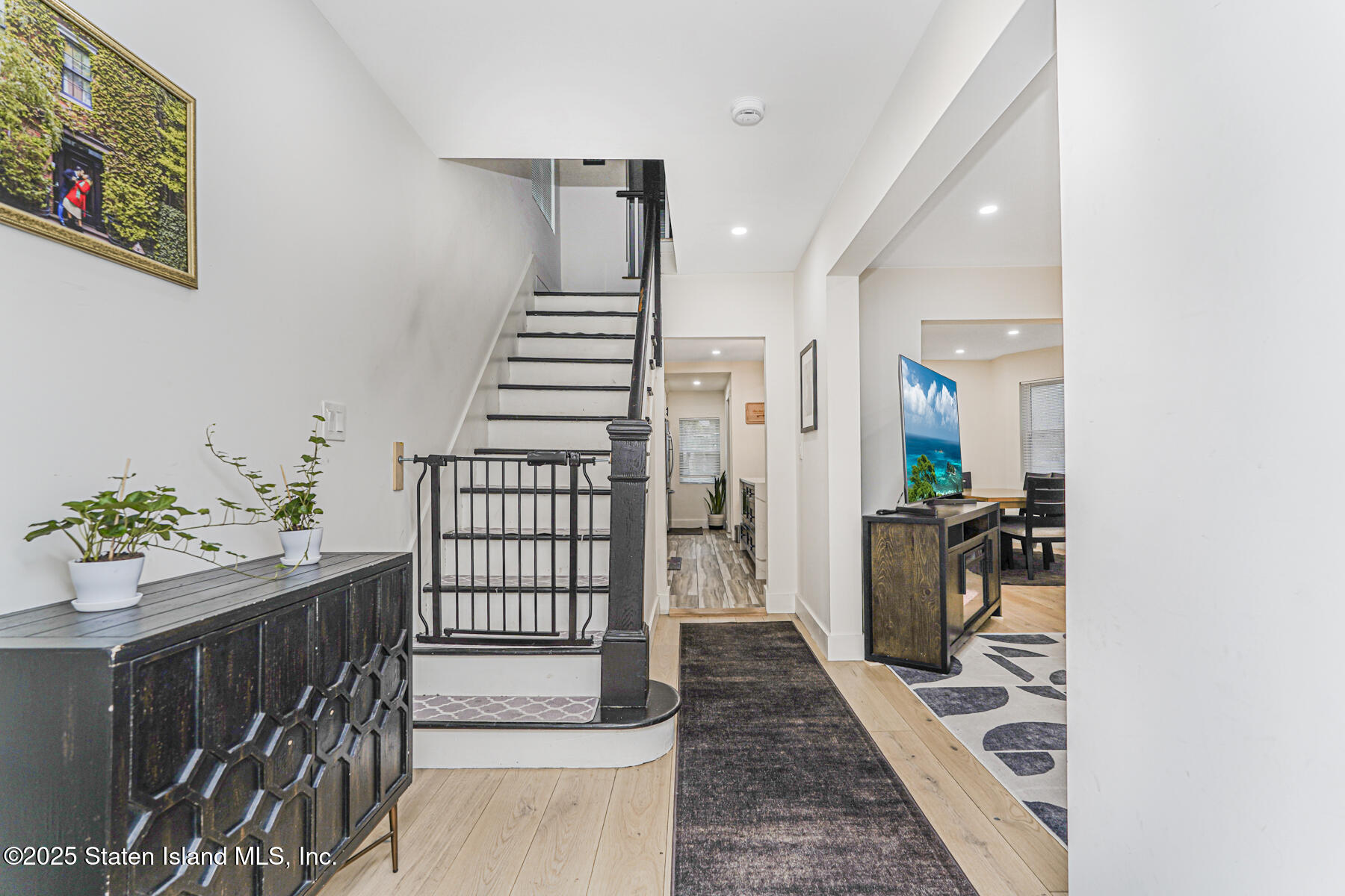 145 Clinton Place Staten Island, NY 10302 - Photo 5 of 41 a hallway with a flower pot and wooden floor