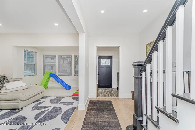 a very nice looking room with a large window and furniture