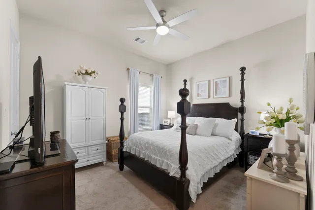 a room with furniture pool table wooden floor and windows