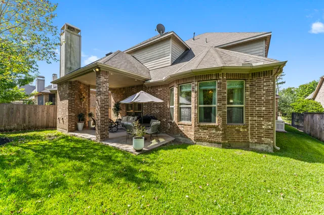 a view of a house with a yard patio and a garden