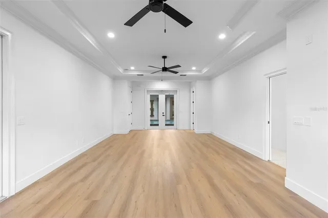 a view of an empty room with a ceiling fan