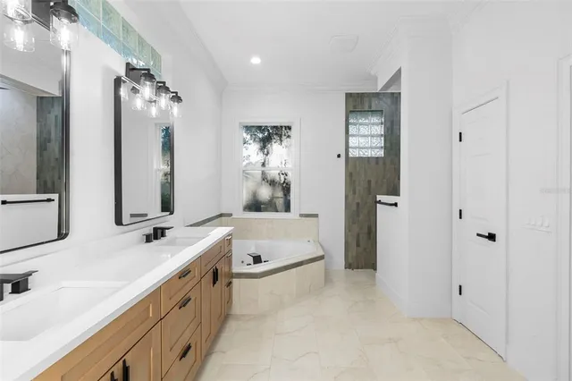 a bathroom with a double vanity sink mirror double and shower