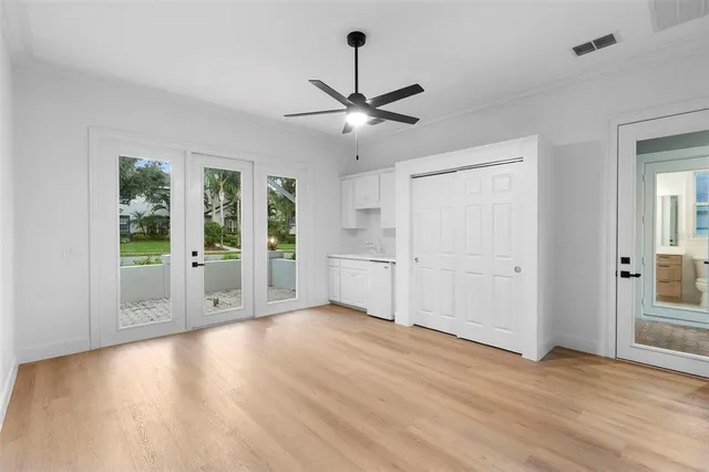 a view of a livingroom with a ceiling fan window and wooden floor