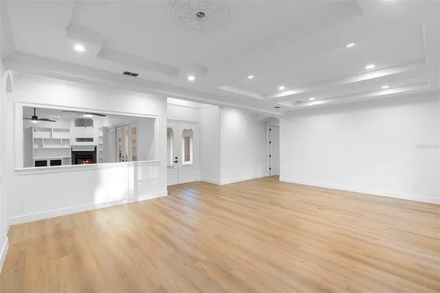 a kitchen with stainless steel appliances kitchen island granite countertop a refrigerator oven a sink with island and chairs