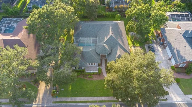 an aerial view of a house with a yard and garden