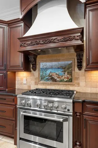 a stove top oven sitting inside of a kitchen