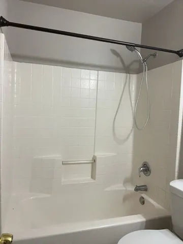 a view of an empty room and chandelier fan