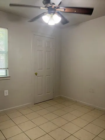 en empty room with fan and window