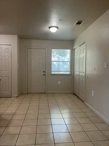 an empty room with windows and closet