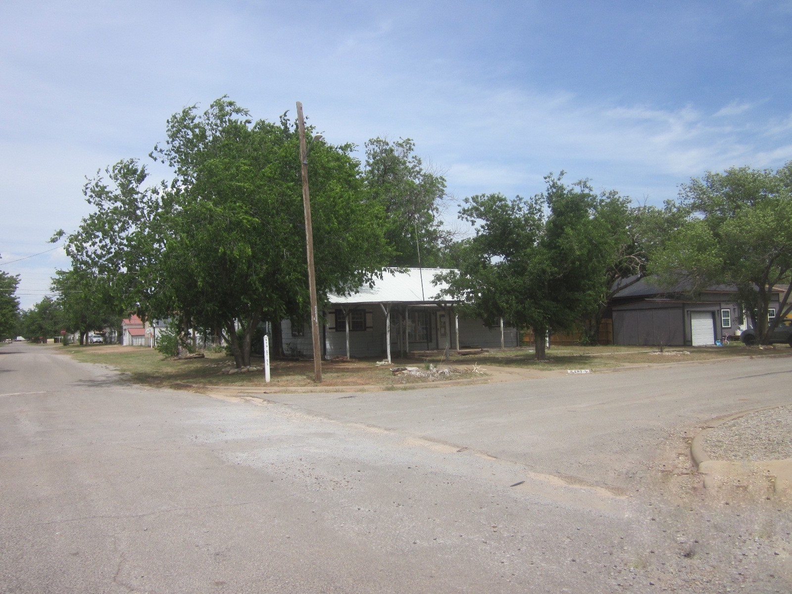 401 Ave F Southeast Childress, TX 79201 - Photo 1 of 10 a backyard of a house with table and chairs and potted plants