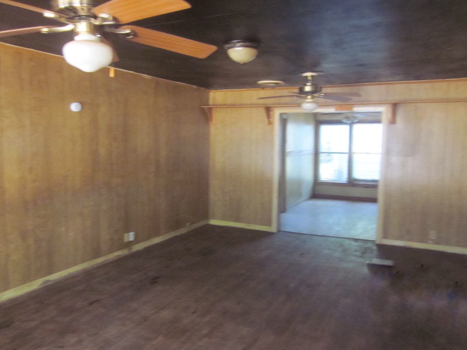 401 Ave F Southeast Childress, TX 79201 - Photo 3 of 10 en empty room with windows and chandelier fan