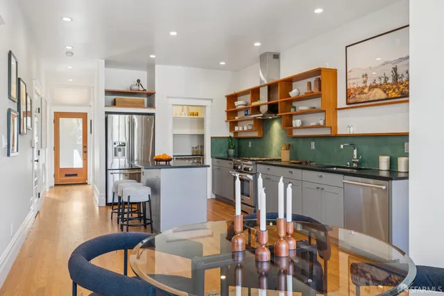 a kitchen with stainless steel appliances granite countertop a sink and a refrigerator