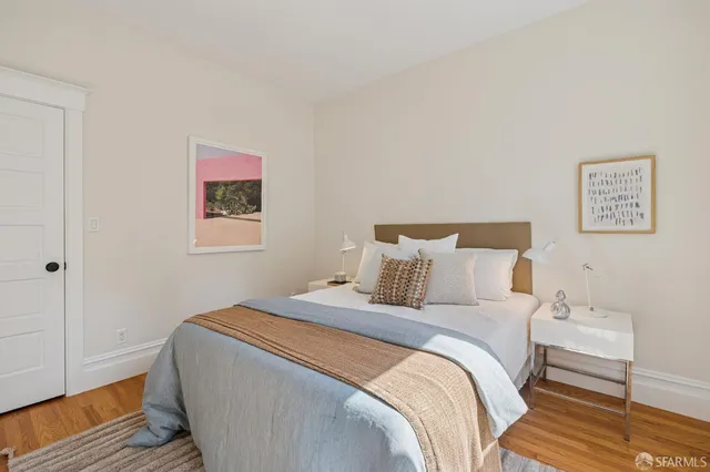 a living room with furniture a mirror and a table