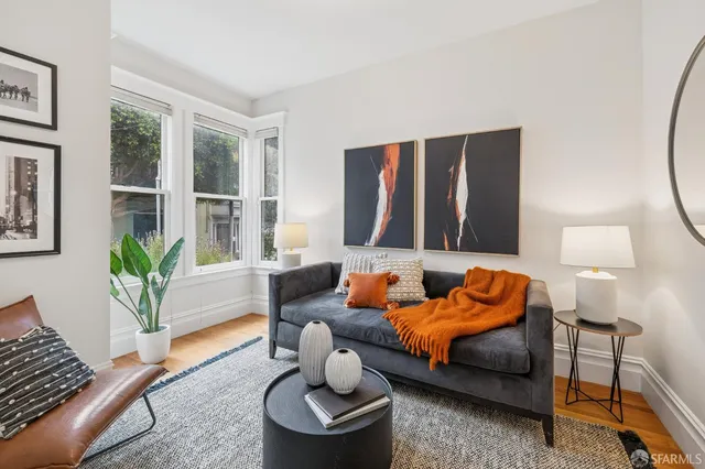 a living room with furniture and a potted plant