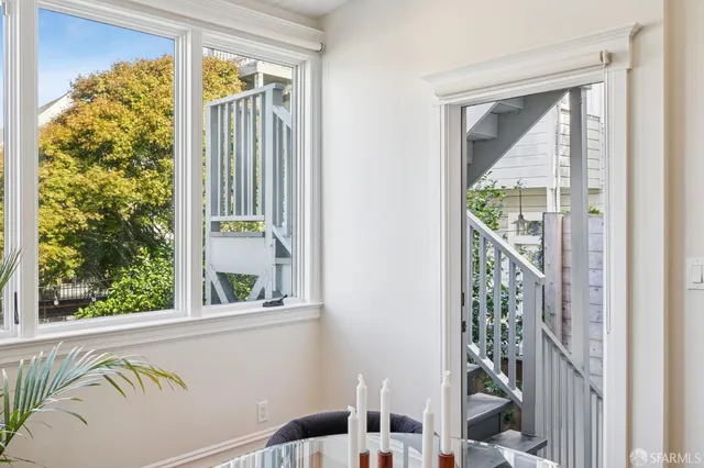 a view of a patio with table and chairs and potted plants