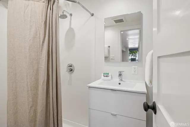 a front view of multi story building with retail shops