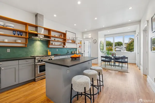 a kitchen with granite countertop a oven and a cabinets