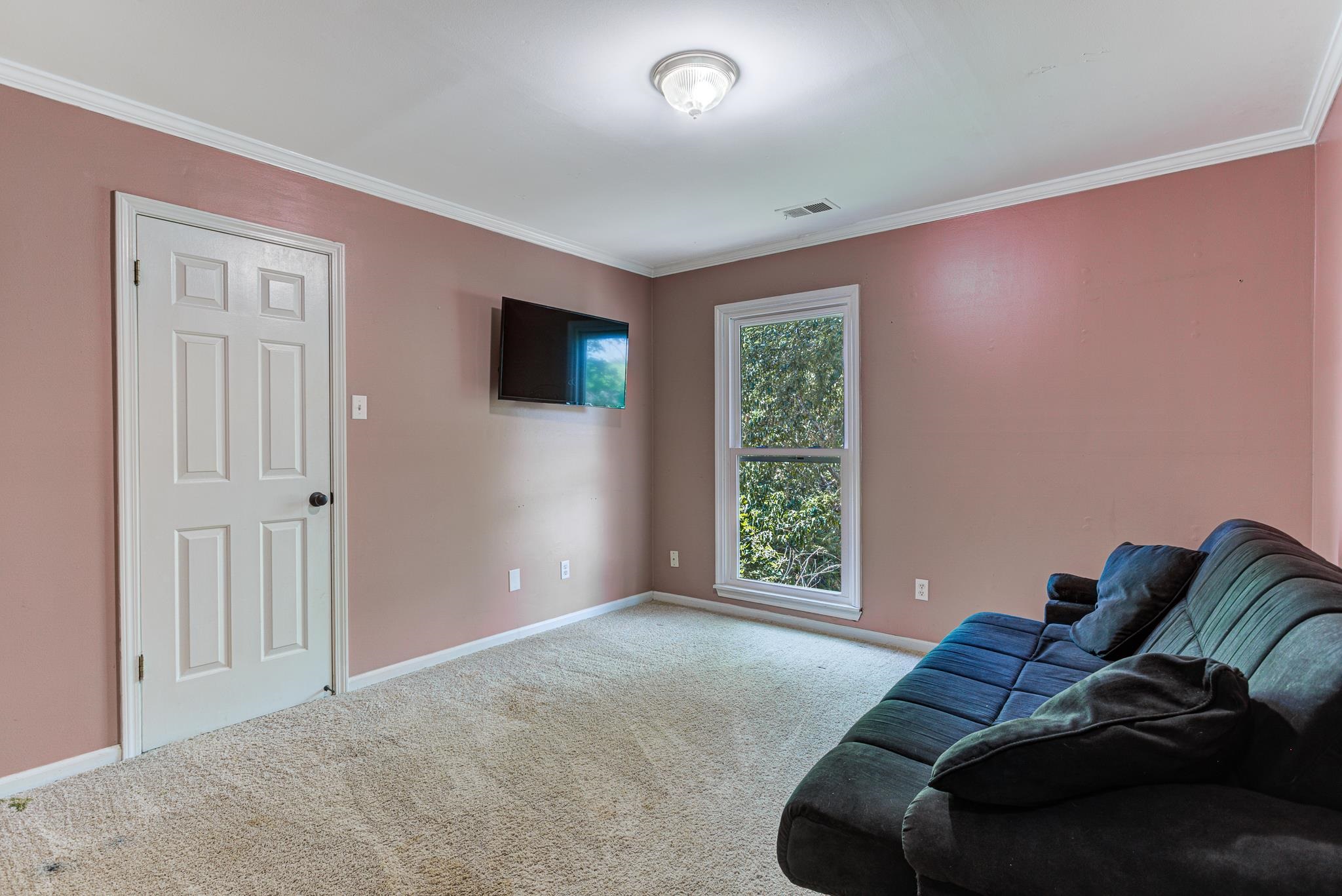 218 South Walnut Bend Road Memphis, TN 38018 - Photo 17 of 25 Unfurnished living room featuring carpet floors and ornamental molding